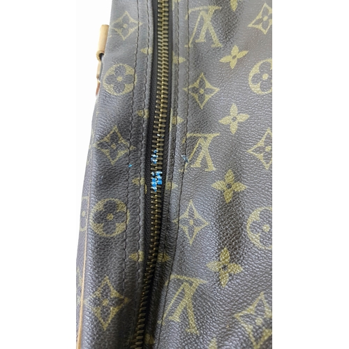 497 - A Louis Vuitton Sirius 70 Travel Bag. Monogram coated canvas exterior with leather trim, two rolled ... 