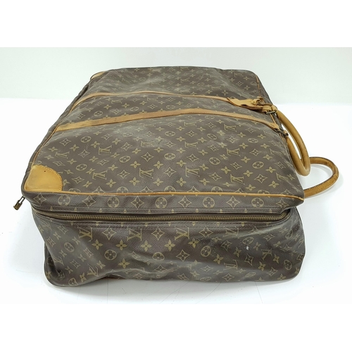 497 - A Louis Vuitton Sirius 70 Travel Bag. Monogram coated canvas exterior with leather trim, two rolled ... 