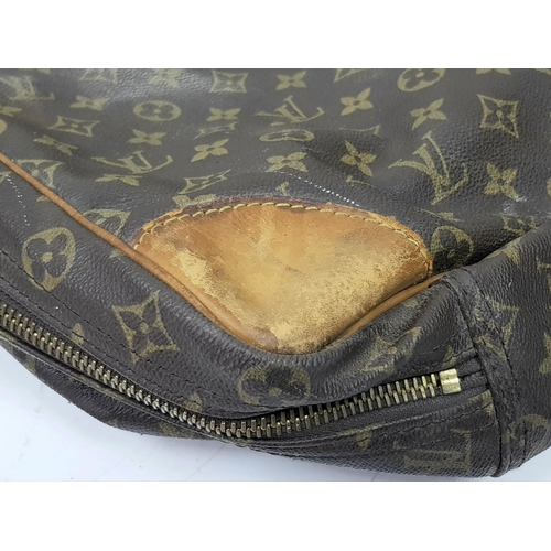 497 - A Louis Vuitton Sirius 70 Travel Bag. Monogram coated canvas exterior with leather trim, two rolled ... 