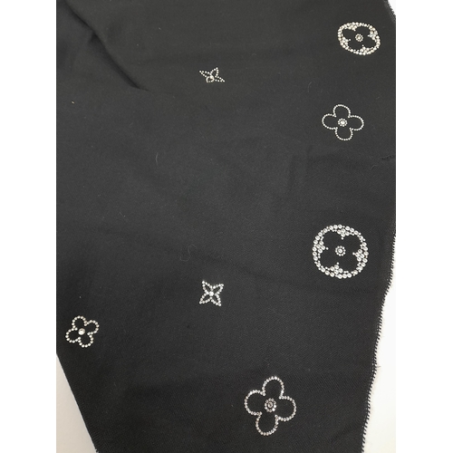 643 - Two Louis Vuitton Scarves. One is black soft cashmere features crystal embellishments forming Louis ... 