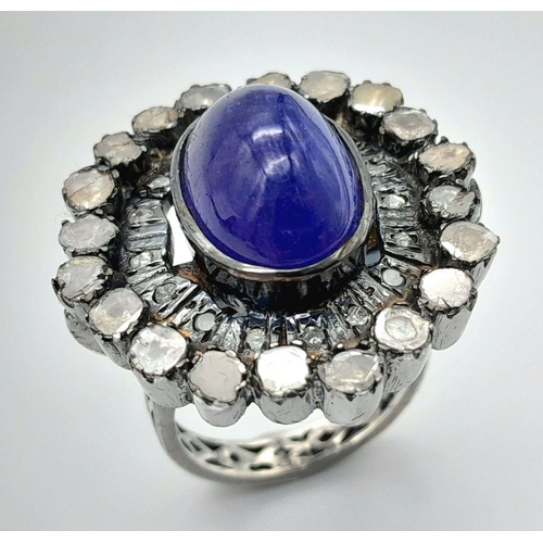 1290 - A 925 silver tanzanite ring featuring a striking 9ct oval-cut tanzanite gemstone at its centre, surr... 