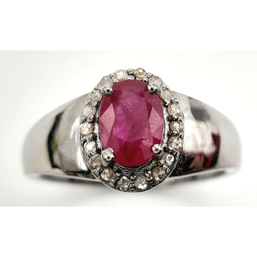 1341 - A 925 Silver with Black Rhodium Ruby Diamonds Ring. A 0.90ct oval-cut Ruby at its center, surrounded... 