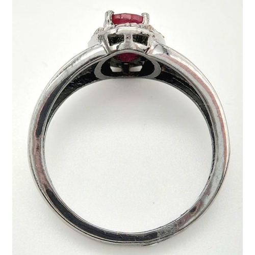 1341 - A 925 Silver with Black Rhodium Ruby Diamonds Ring. A 0.90ct oval-cut Ruby at its center, surrounded... 