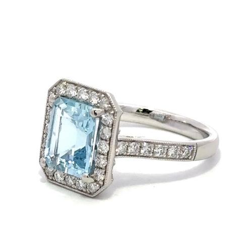 1208 - A PLATINUM HALO RING FEATURING A 2.02CT EMERALD CUT AQUAMARINE CENTER STONE, SURROUNDED BY 0.57CT OF... 