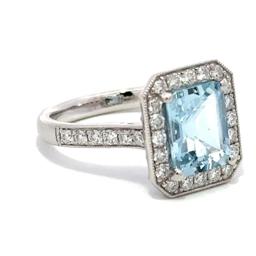 1208 - A PLATINUM HALO RING FEATURING A 2.02CT EMERALD CUT AQUAMARINE CENTER STONE, SURROUNDED BY 0.57CT OF... 