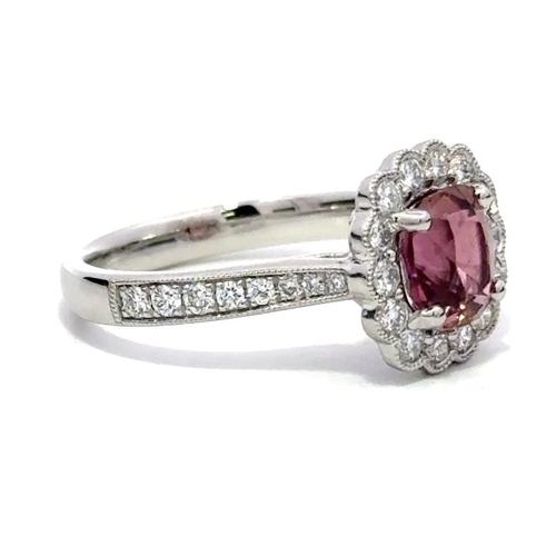 1215 - A PLATINUM HALO RING FEATURING A 1.47CT CUSHION PINK TOURMALINE AND 0.60CT ROUND DIAMONDS IN A CLAW ... 