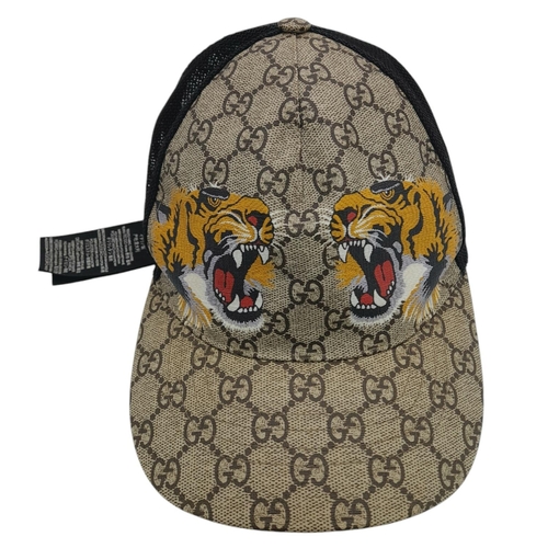 1064 - A Gucci Tiger GG Supreme Cap. Monogram coated canvas and textile exterior with printed tigers and ad... 