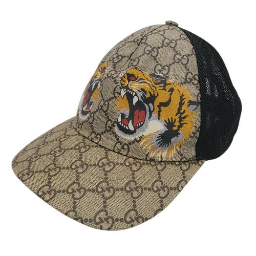 1064 - A Gucci Tiger GG Supreme Cap. Monogram coated canvas and textile exterior with printed tigers and ad... 