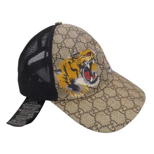 1064 - A Gucci Tiger GG Supreme Cap. Monogram coated canvas and textile exterior with printed tigers and ad... 