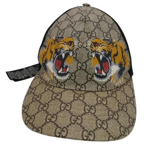 1064 - A Gucci Tiger GG Supreme Cap. Monogram coated canvas and textile exterior with printed tigers and ad... 