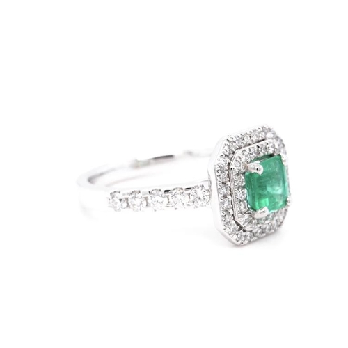 1381 - A PLATINUM CLUSTER RING FEATURING A 0.79CT EMERALD AND 0.64CT ROUND DIAMONDS. RING SIZE L 1/2. WED F... 