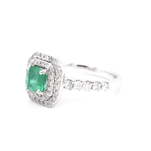 1381 - A PLATINUM CLUSTER RING FEATURING A 0.79CT EMERALD AND 0.64CT ROUND DIAMONDS. RING SIZE L 1/2. WED F... 