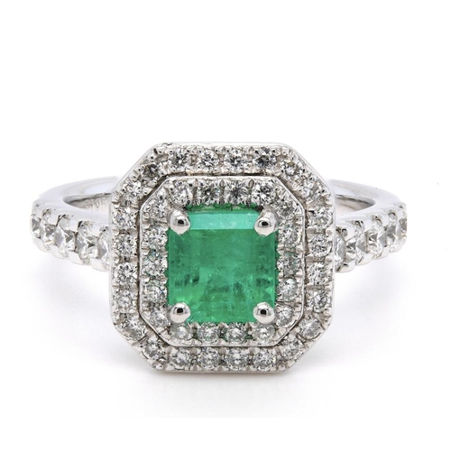 1381 - A PLATINUM CLUSTER RING FEATURING A 0.79CT EMERALD AND 0.64CT ROUND DIAMONDS. RING SIZE L 1/2. WED F... 