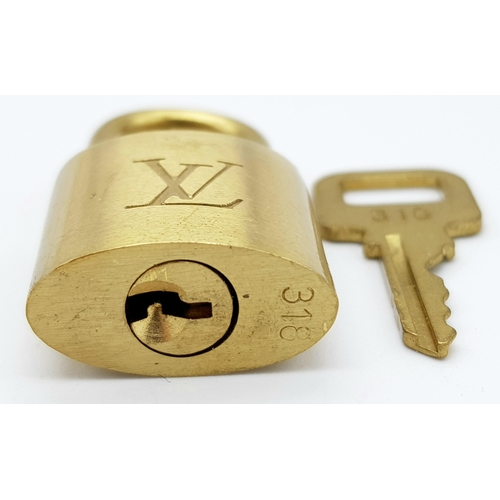 170 - A Louis Vuitton Case Lock and Key. Gilded metal. LV monogram. Good condition.