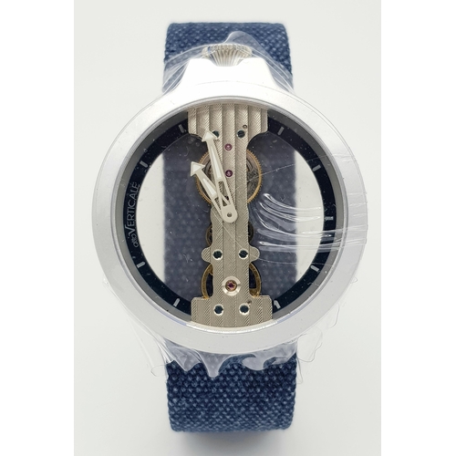 542 - A Verticale Mechanical Top Winder Gents Watch. Blue textile strap. Ceramic silver tone skeleton case... 