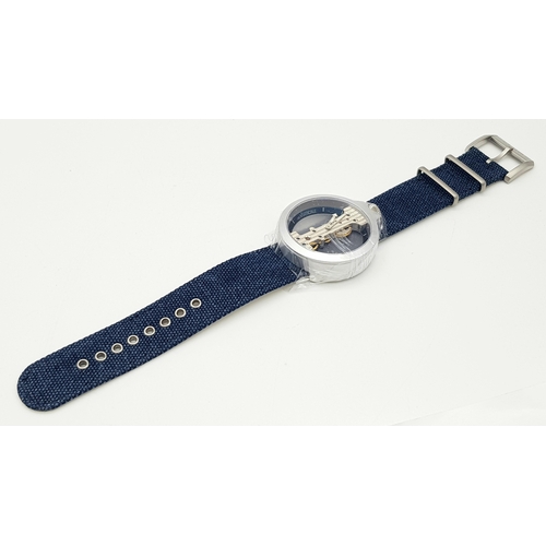 542 - A Verticale Mechanical Top Winder Gents Watch. Blue textile strap. Ceramic silver tone skeleton case... 