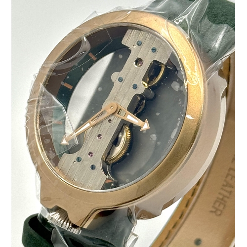 738 - A Verticale Mechanical Top Winder Gents Watch. Green leather strap. Ceramic gold tone skeleton case ... 