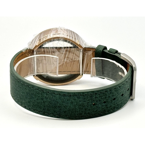 738 - A Verticale Mechanical Top Winder Gents Watch. Green leather strap. Ceramic gold tone skeleton case ... 