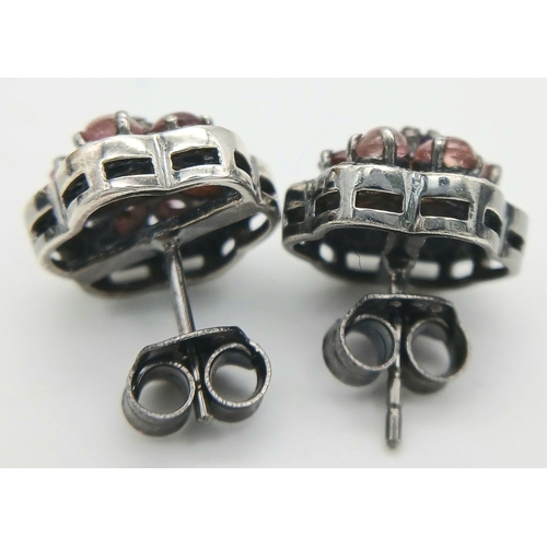 1389 - A pair of 925 silver stud earrings featuring tourmaline gemstones in a floral design, surrounded by ... 