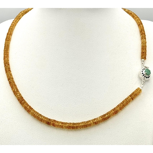 1383 - An 85ct AAA quality citrine gemstone necklace featuring faceted citrine beads and an emerald-accente... 