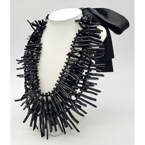 223 - A highly glamorous and rarely seen, three-strand, genuine black coral necklace presented in a vintag... 