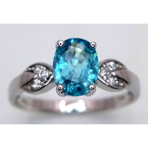 390 - A 10 Carat White Gold Blue and White Topaz Set Ring Size S. The Ring is set with a 9mm Oval Cut Blue... 