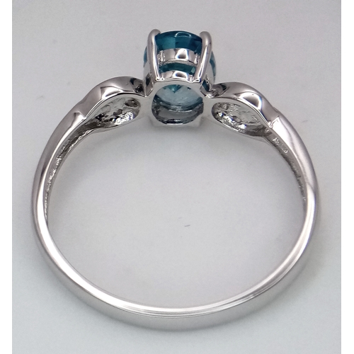 390 - A 10 Carat White Gold Blue and White Topaz Set Ring Size S. The Ring is set with a 9mm Oval Cut Blue... 