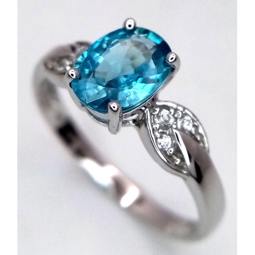 390 - A 10 Carat White Gold Blue and White Topaz Set Ring Size S. The Ring is set with a 9mm Oval Cut Blue... 