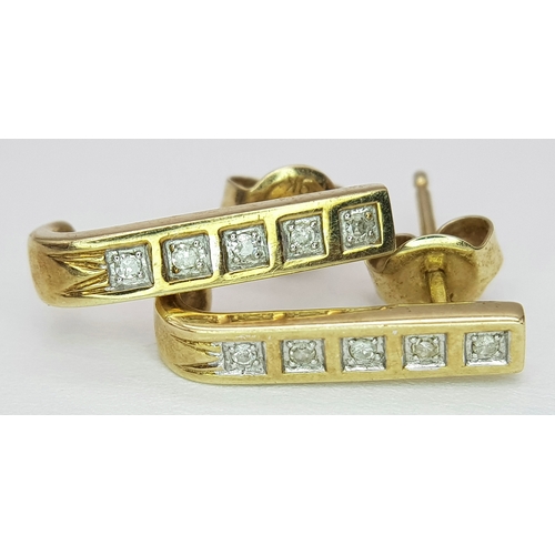 488 - A Pair of 9 Carat Gold ‘J Shape’ Diamond Stud Earrings. Set with Ten 1.5mm Square Cut Diamonds (Appr... 