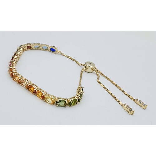 1076 - A Yellow Gold Gilt Sterling Silver Multi Colour Stone Pull Through Bracelet. One Size Adjustable Fit... 