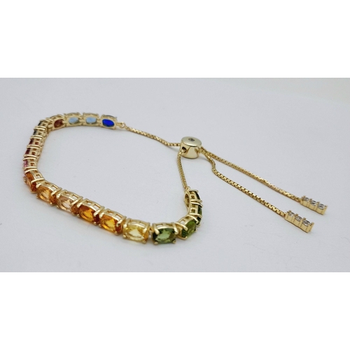 1076 - A Yellow Gold Gilt Sterling Silver Multi Colour Stone Pull Through Bracelet. One Size Adjustable Fit... 