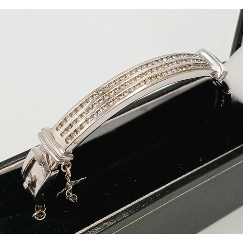 112 - Hinged  DIAMOND BANGLE set  in 9 CARAT WHITE GOLD. Complete with safety chain. Condition as new. 19 ... 