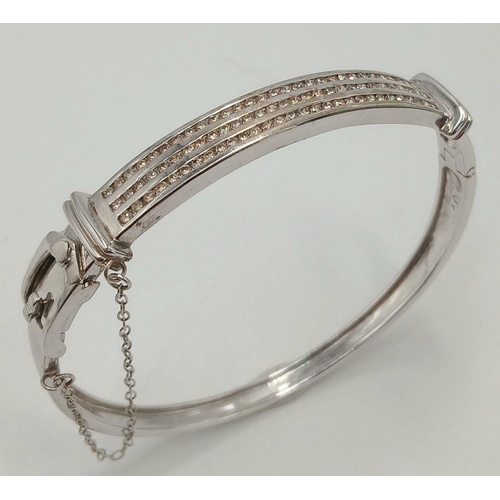 112 - Hinged  DIAMOND BANGLE set  in 9 CARAT WHITE GOLD. Complete with safety chain. Condition as new. 19 ... 