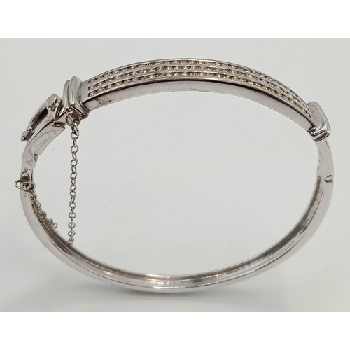 112 - Hinged  DIAMOND BANGLE set  in 9 CARAT WHITE GOLD. Complete with safety chain. Condition as new. 19 ... 