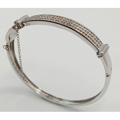 112 - Hinged  DIAMOND BANGLE set  in 9 CARAT WHITE GOLD. Complete with safety chain. Condition as new. 19 ... 