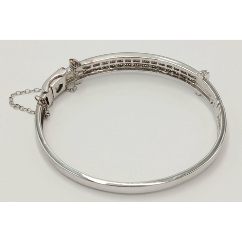 112 - Hinged  DIAMOND BANGLE set  in 9 CARAT WHITE GOLD. Complete with safety chain. Condition as new. 19 ... 