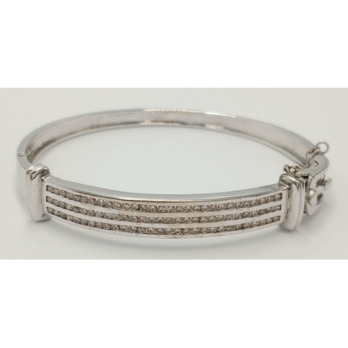 112 - Hinged  DIAMOND BANGLE set  in 9 CARAT WHITE GOLD. Complete with safety chain. Condition as new. 19 ... 