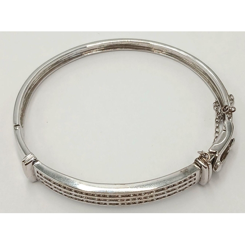 112 - Hinged  DIAMOND BANGLE set  in 9 CARAT WHITE GOLD. Complete with safety chain. Condition as new. 19 ... 