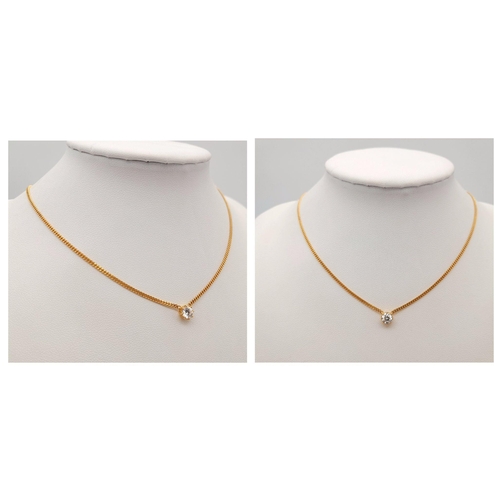 12 - AN 18K YELLOW GOLD DIAMOND SOLITAIRE PENDANT ON AN 18 INCH, 18K YELLOW GOLD CURB CHAIN. 0.40CT ROUND... 