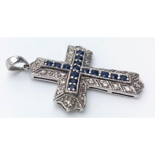 172 - A 9K WHITE GOLD DIAMOND & SAPPHIRE SET CROSS PENDANT. 2.9G. JB7101.