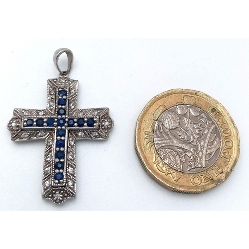 172 - A 9K WHITE GOLD DIAMOND & SAPPHIRE SET CROSS PENDANT. 2.9G. JB7101.