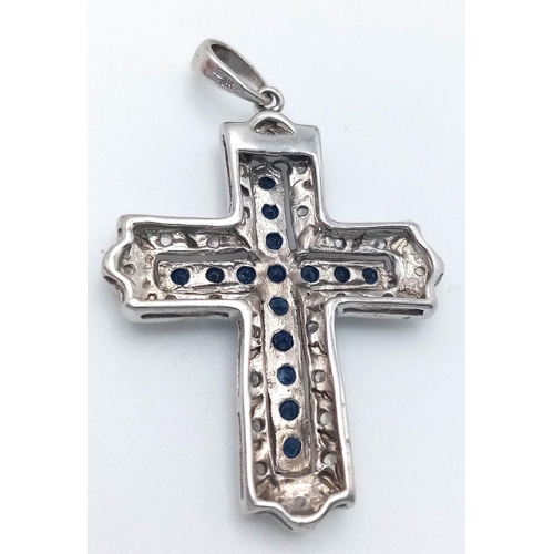 172 - A 9K WHITE GOLD DIAMOND & SAPPHIRE SET CROSS PENDANT. 2.9G. JB7101.