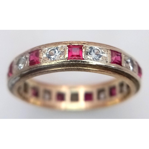 179 - A 9K YELLOW GOLD DIAMOND & RUBY FULL ETERNITY RING. 3G. SIZE N. ADAM2003.