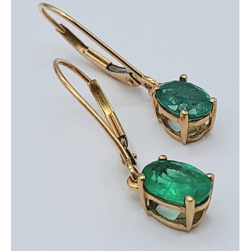 197 - A PAIR OF 9K YELLOW GOLD EMERALD SET DROP EARRINGS 2CT OVAL EMERALDS TOTAL 1.2G, 2CM LENGTH. Ref: SC... 