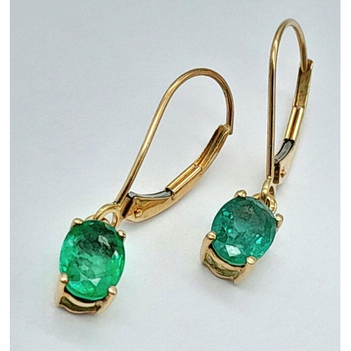 197 - A PAIR OF 9K YELLOW GOLD EMERALD SET DROP EARRINGS 2CT OVAL EMERALDS TOTAL 1.2G, 2CM LENGTH. Ref: SC... 