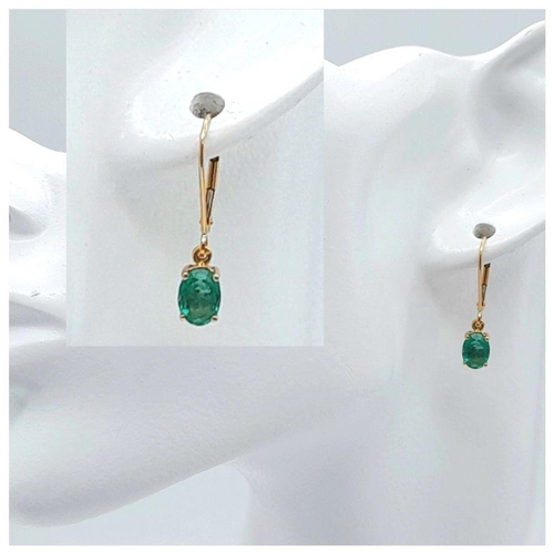 197 - A PAIR OF 9K YELLOW GOLD EMERALD SET DROP EARRINGS 2CT OVAL EMERALDS TOTAL 1.2G, 2CM LENGTH. Ref: SC... 