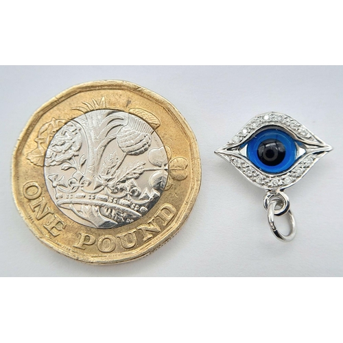 198 - AN 18K WHITE GOLD DIAMOND SET EVIL EYE PENDANT / CHARM 1.4CM x 1CM, 1.9G TOTAL WEIGHT,. Ref: SC 2052