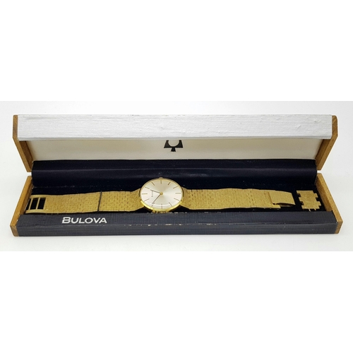 578 - A Men’s Swiss Gold Tone Manual Wind Watch by Bulova. 33mm Case. Comes with Spare Link and Original B... 