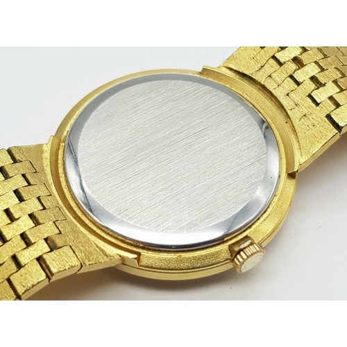 578 - A Men’s Swiss Gold Tone Manual Wind Watch by Bulova. 33mm Case. Comes with Spare Link and Original B... 