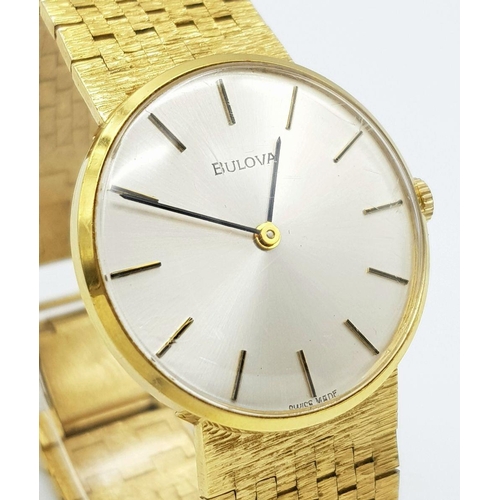 578 - A Men’s Swiss Gold Tone Manual Wind Watch by Bulova. 33mm Case. Comes with Spare Link and Original B... 